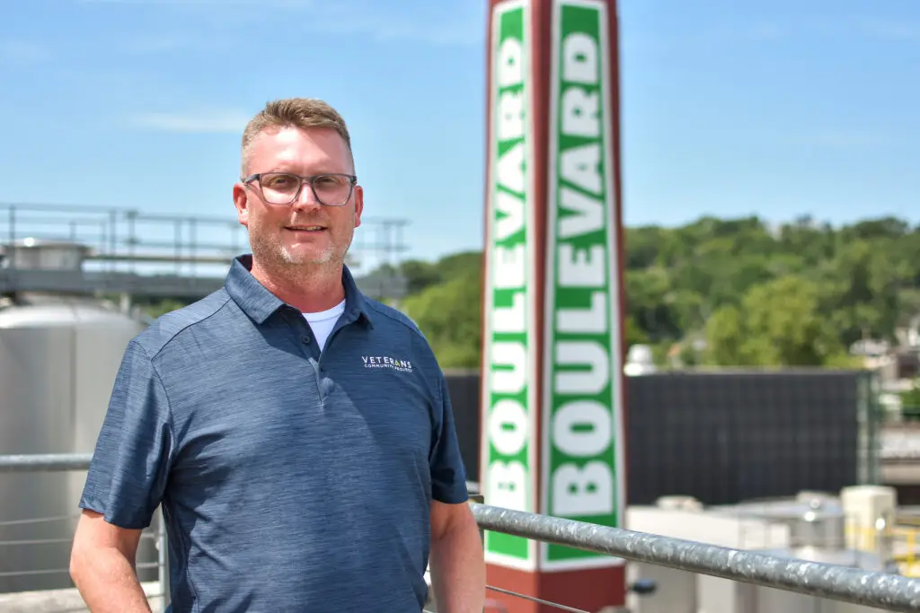 Man standing near Boulevard sign.